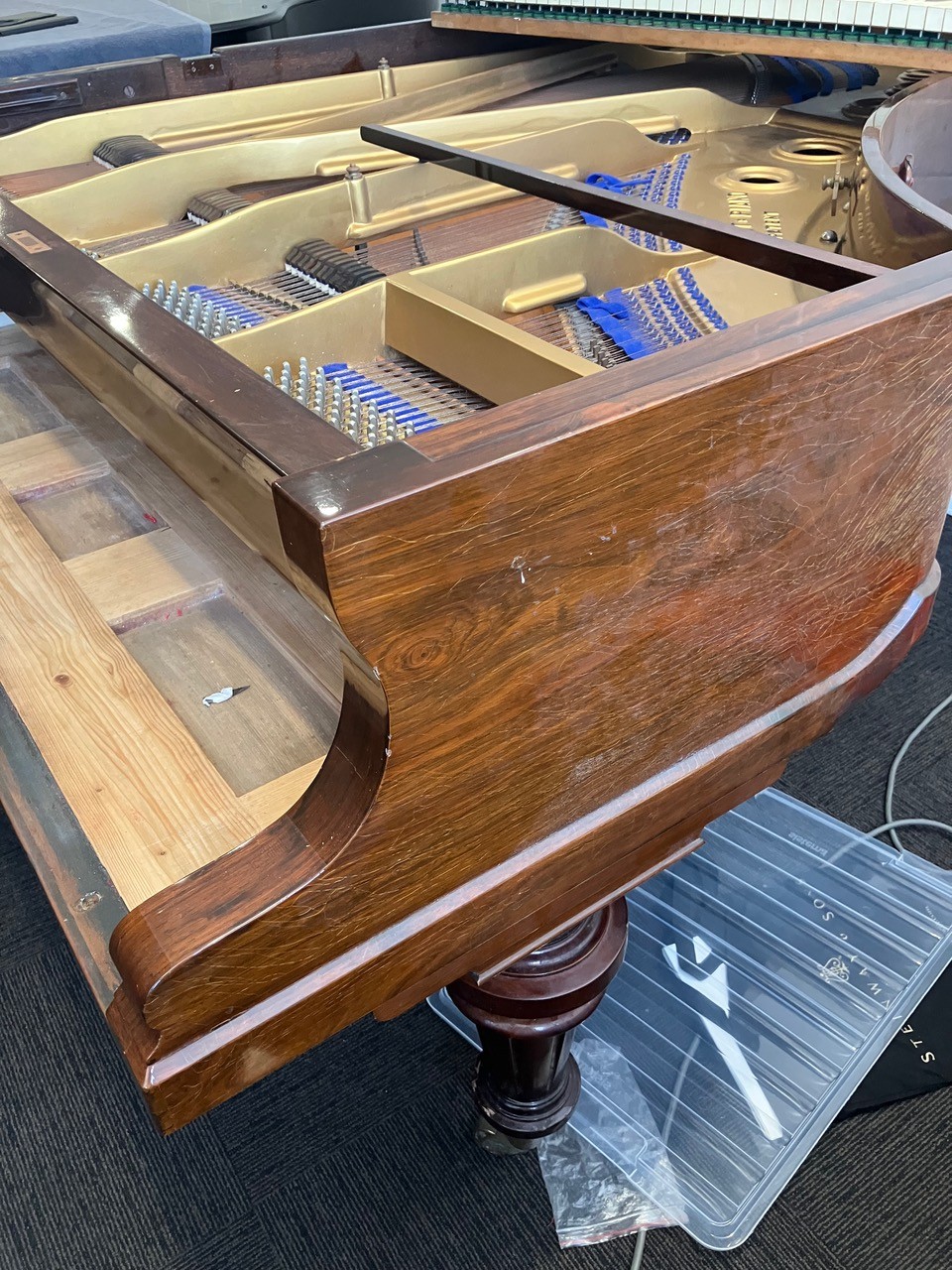 Bluthner grand piano with scratched casework before restoration