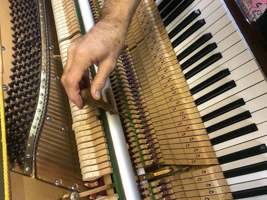 David Cremer tuning an upright piano action with a tuning lever